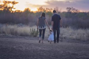 Father and mother walking with their child in Las Vegas.