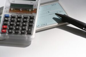 Calculator, check, and pen symbolizing Las Vegas child support payment calculations
